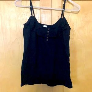 Black tank top with ruffle detail.